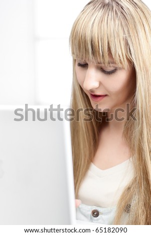 woman in office with blond hair with laptop