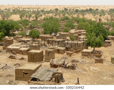 Traditional tribal village with flat-roofed mud dwellings and granaries in the West African nation of Mali.