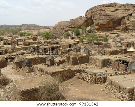 Tribal village in the West African nation of Mali. Village consists of flat-roofed dwellings and granaries with thatched roofs.