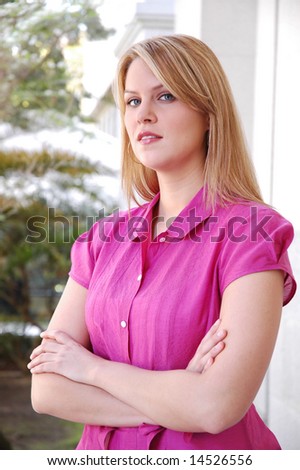portrait of young blond woman in pink blouse