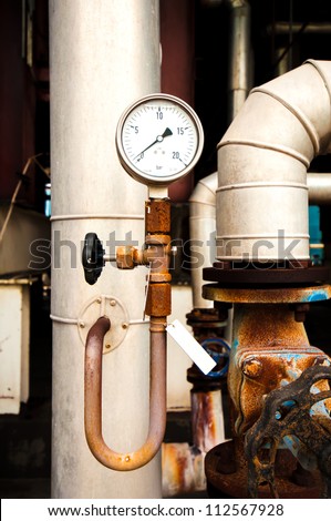 manometer, pipes and faucet valves of heating system in a boiler room