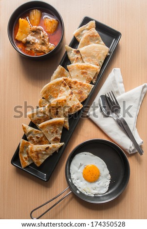 Chicken curry with roti and egg, Indian meal
