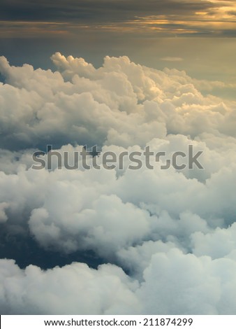 Clouds and sky with dramatic heaven light as seen through window of an aircraft