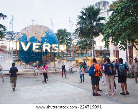 SINGAPORE - MARCH 07: Tourists and theme park visitors taking pictures of the large rotating globe fountain in front of Universal Studios on MARCH 07, 2014 in Sentosa island, Singapore