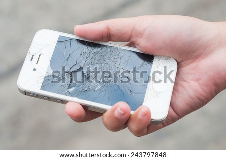 Hands holding broken mobile smartphone