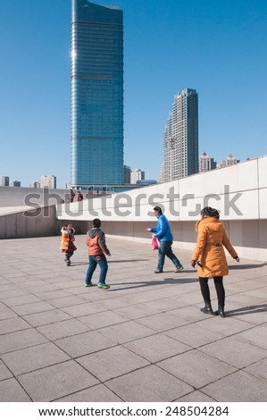 Dalian, China - January 19, 2015 : Chinese family enjoy the activities at Xinghai Square.T he Square covers total area of 1.1 million square metre, making it the largest city square in the world.