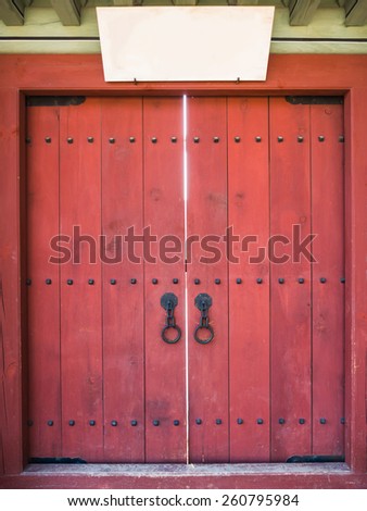 Red asian style door with blank space label.
