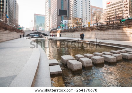 SEOUL, SOUTH KOREA - FEBRUARY 28, 2015: People at Cheonggyecheon stream. The stream is a 10.9Ã?ÃÂ km long, modern public recreation space in Seoul downtown.