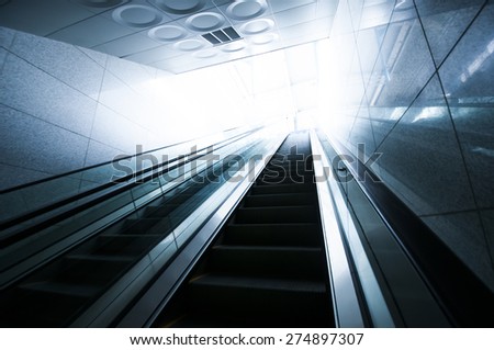 Escalator and light at end of tunnel
