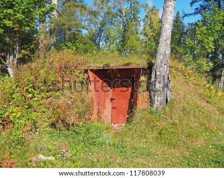 Entrance in an air-raid shelter underground in the forest. Russia. Karelia.