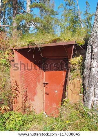 Entrance in an air-raid shelter underground in the forest. Russia. Karelia.