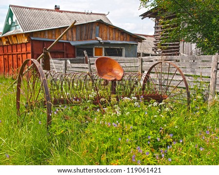 Old agricultural machinery. Summer in the village.