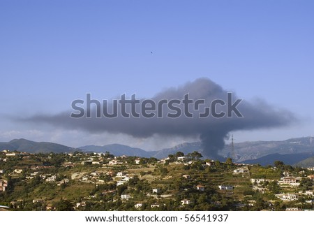 Dark cloud of pollution due to a factory on fire. Nice, French Riviera. June 2010