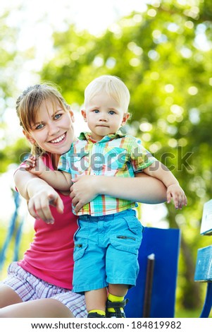 Spring portrait of mother and son on Mother\'s Day. Family walk in the park