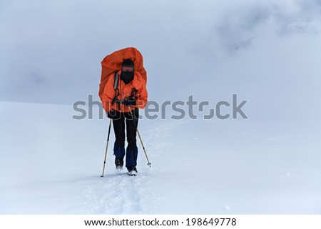 hiker in the mountain. Climb to the top. winter hiking