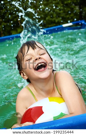 funny little girl in swimming pool. children outdoors