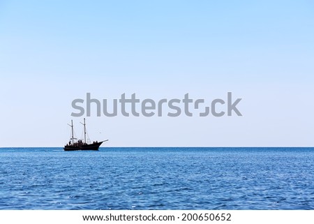 sailing ship the high seas on the horizon in good weather on a background of blue sky. marine background. marine tourism