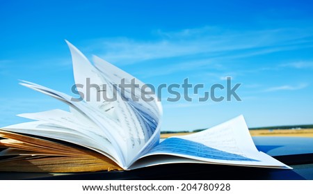 open music book on sky background. music education