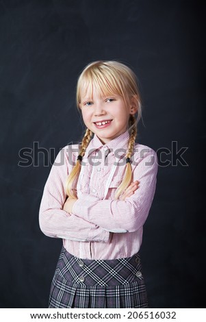 Portrait of a schoolchild on a background of the board. School and education