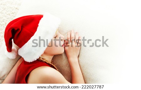 portrait of a sleeping girl in a Santa hat. Christmas child