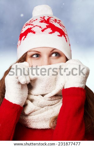 attractive woman in winter clothes with white gloves and hat