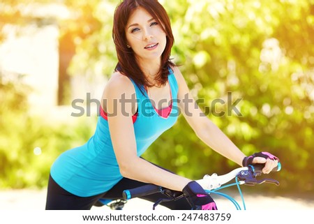 young woman with a bike in a summer park. Active people outdoors. sport lifestyle