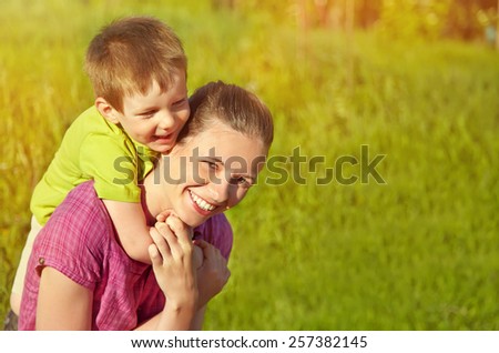 Spring portrait of mother and son on Mother\'s Day. Family walk in the park