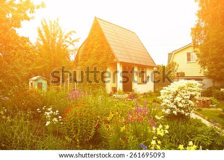 wonderful rustic country house in the lush garden. garden flowers