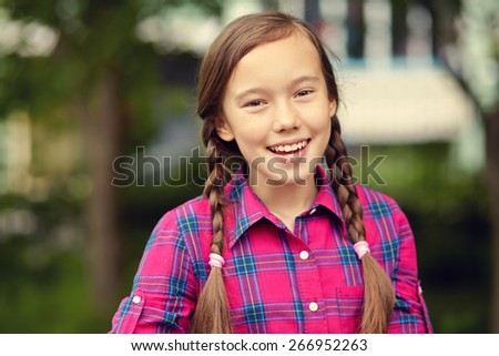 portrait of a beautiful teenage girl in a summer park. youth lifestyle
