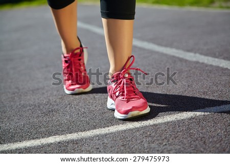selective focus.. runner feet closeup. athlete running on jogging track at the stadium. running shoes. jogging outdoors