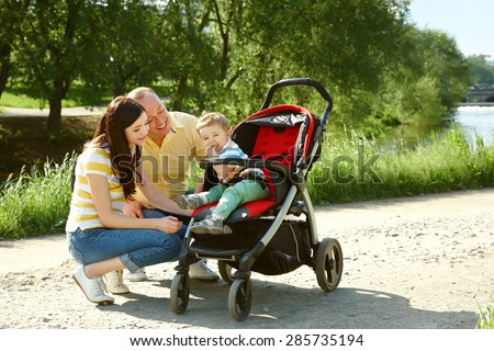 outdoor portrait of a family. young parents with a baby for a walk in the summer park. Mom, dad and child