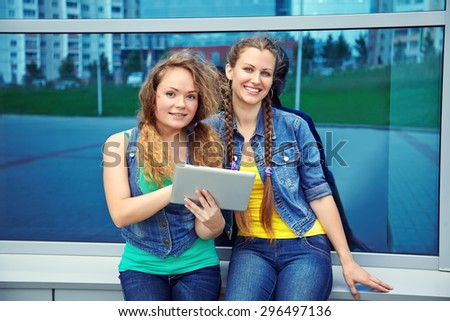 two friends with tablet computer.  youth lifestyle. students girls