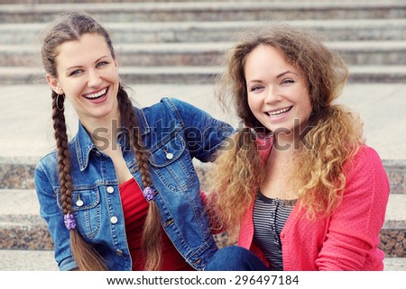 portrait of a two friends on the steps of the University. youth lifestyle. students girls