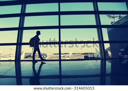 traveler at the airport. silhouette of a woman with a backpack. business and travel