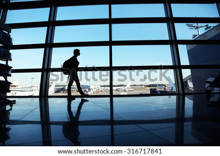 traveler at the airport. silhouette of a woman with a backpack. business and travel