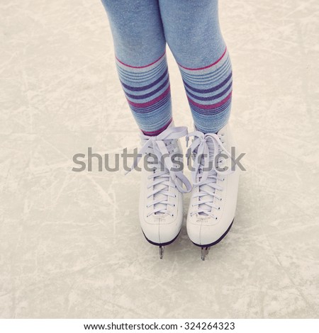 girl ice skating. child winter outdoors on ice rink. ice and legs