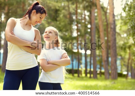 sporty mother and daughter. woman and child training in the park. outdoor sports and fitness. healthy sport lifestyle