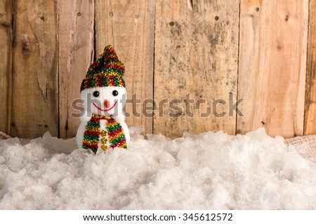 happy snow ball  on snow and wooden background