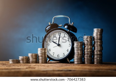 business financial ideas concept with coins stack and alarmclock isolate background with free copyspace for your creativity ideas text