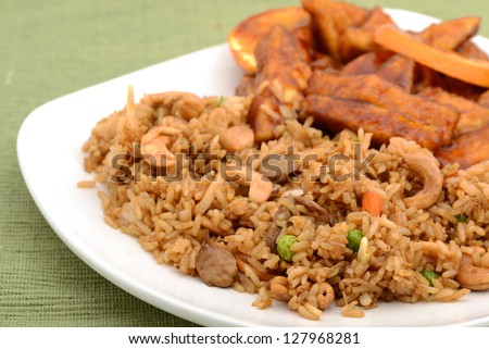A vegetarian meal of fried rice on a plate with tofu at an Asian restaurant