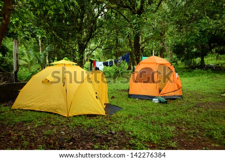 two tents on campground with laundry hanging up to dry on line
