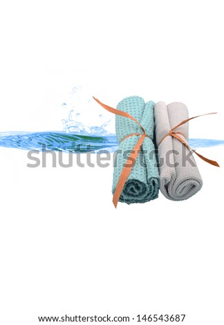 clean wash cloths and a splash of water for spa arrangement