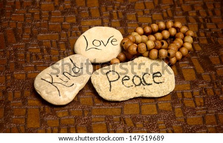 peaceful scene with rocks with words peace, love and kind for meditation