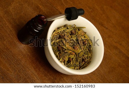 essential oil with scented herbs for aromatherapy on wood