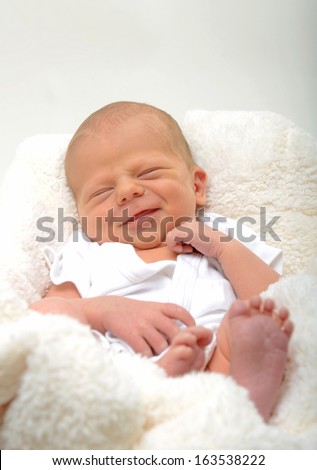 happy newborn baby with a big smile