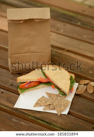 healthy back to school lunch with veggie sandwich and brown paper bag