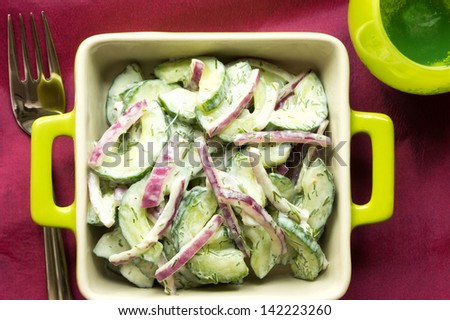 Delicious and healthy cucumber and red onion salad with low fat sour cream dressing