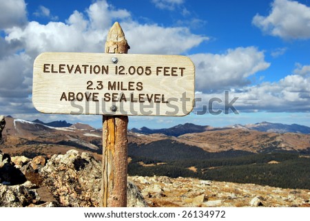 Elevation 12,005 Feet, 2.3 Miles Above Sea Level sign at the top of Rocky Mountain National Park in Colorado