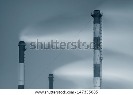 smokestack tubes on sky background. air pollution problem