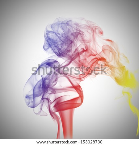 Abstract colorful fume swirls over the white background